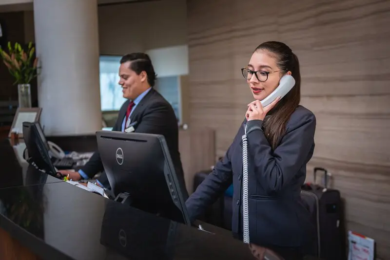 Hotel Receptionist is answering the phone (picture taken with Nikon D810 and Nikon AF-S 24-70mm F2.8 G ED)