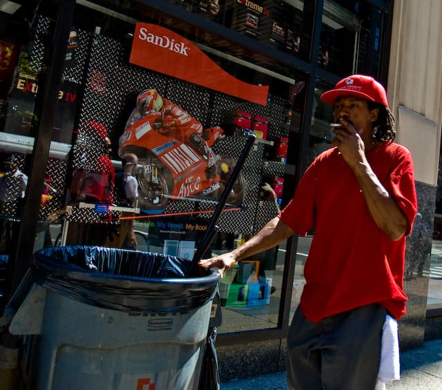 Guy with garbage can wears red and smokes (picture taken with Canon EOS 1D Mark III and Canon EF 16-35mm F2.8 L USM)