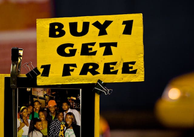 Yellow sign that says Buy 1 Get 1 Free (picture taken with Canon EOS 1D Mark III and Canon EF 135mm F2 L USM )