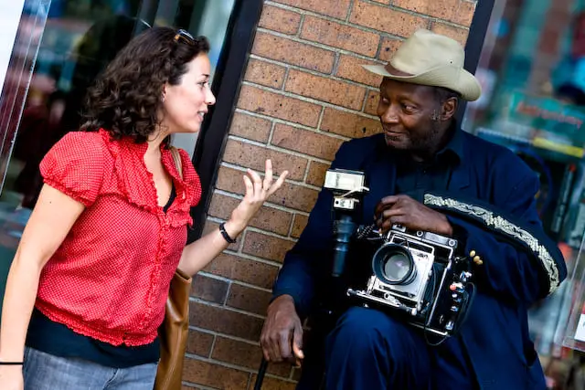 Woman stops buy an older camera guy (picture taken with Canon EOS 1D Mark III and Canon EF 135mm F2 L USM )