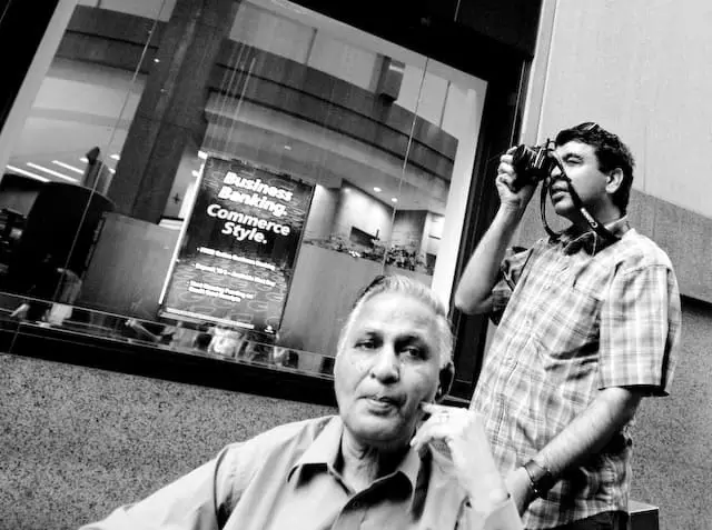Guy taking a picture outside of a bank (picture taken with Canon EOS 1D Mark III and Canon EF 16-35mm F2.8 L USM)