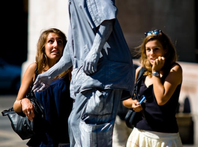 Two girls are frightened by street performer (picture taken with Canon EOS 1D Mark III and Canon EF 135mm f/2 L USM )