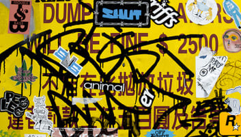 Yellow sign with graffiti and stickers