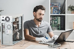 Computer specialist at his repair studio