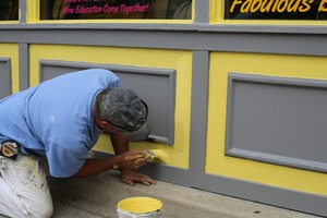Painter is painting outside a store