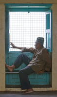 Nepalese gentleman is looking out of window